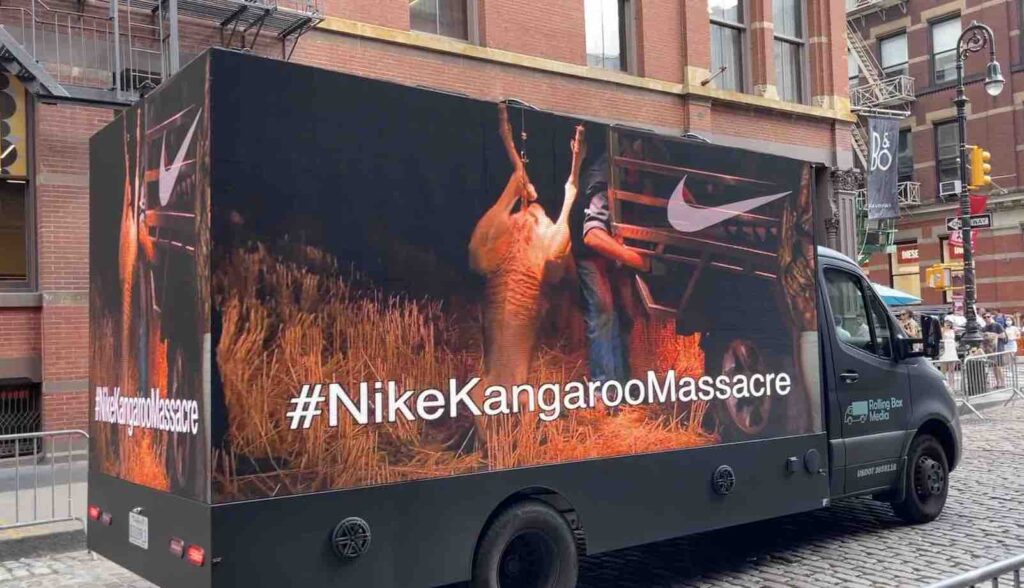 Photo of a mobile billboard in NYC displaying video footage of commercial hunters in Australia shooting wild kangaroos for companies like Nike that use the animals' skin to make soccer shoes