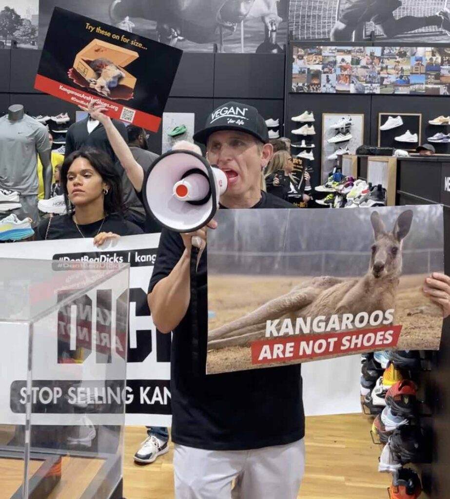Photo of animal rights activists in NYC protesting inside of a Dick's Sporting Goods
